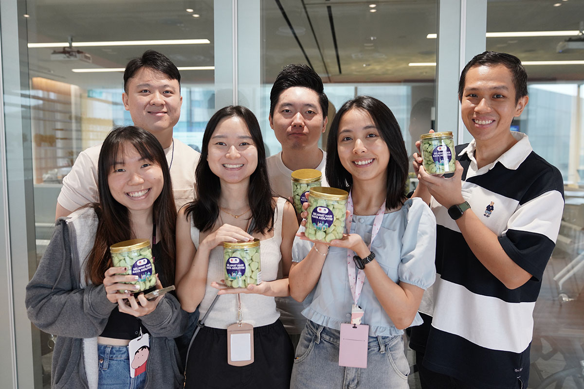 Team holding cookie jars at Shopee celebration